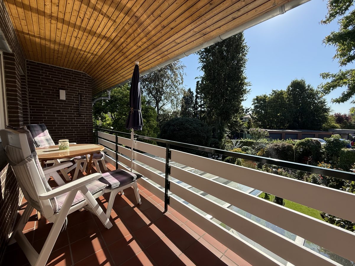 Covered balcony of the holiday apartment with a wide view over the garden